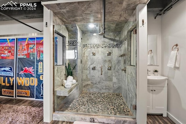 bathroom with vanity, wood-type flooring, and an enclosed shower