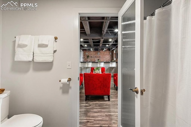 bathroom featuring hardwood / wood-style floors and toilet