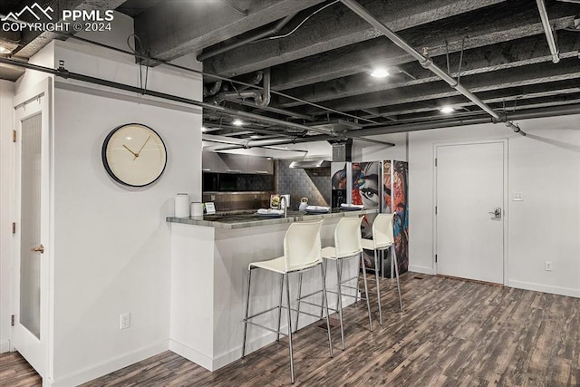 kitchen with hardwood / wood-style floors and tasteful backsplash