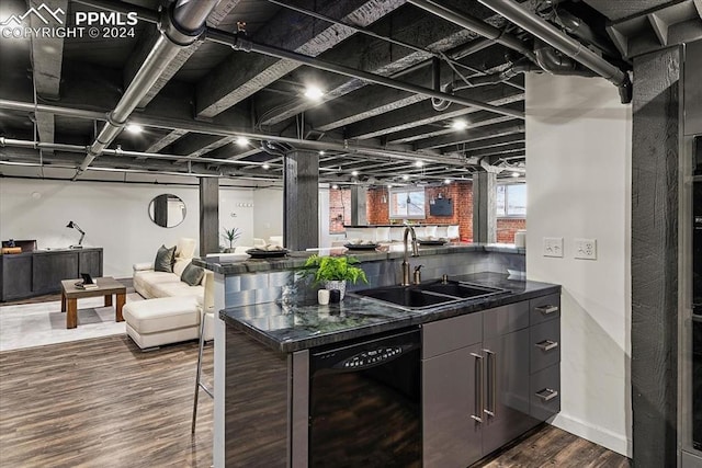 kitchen featuring dark hardwood / wood-style flooring, sink, and black dishwasher