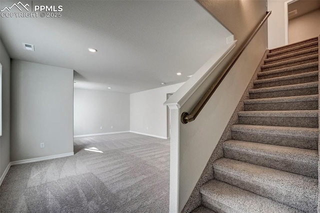 stairway featuring baseboards, visible vents, carpet flooring, and recessed lighting