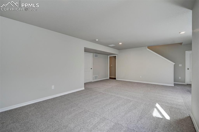 carpeted spare room featuring recessed lighting, visible vents, and baseboards