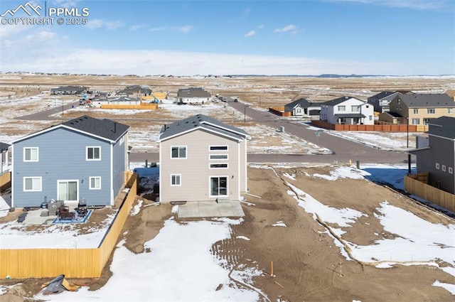 snowy aerial view featuring a residential view