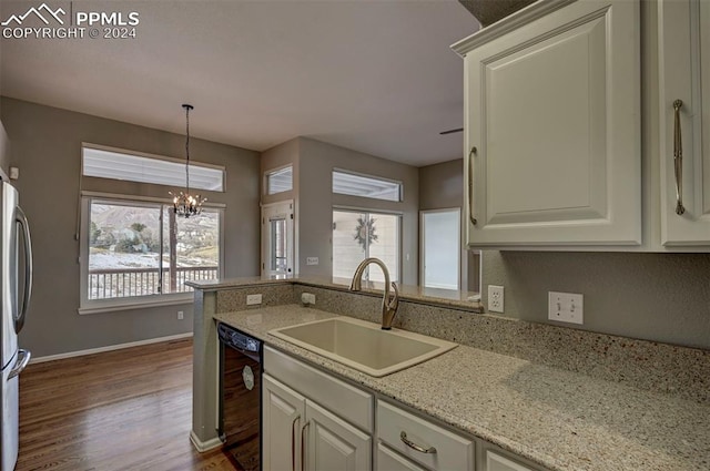 kitchen featuring dishwasher, wood-type flooring, sink, and a wealth of natural light