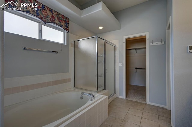 bathroom featuring tile patterned floors and shower with separate bathtub