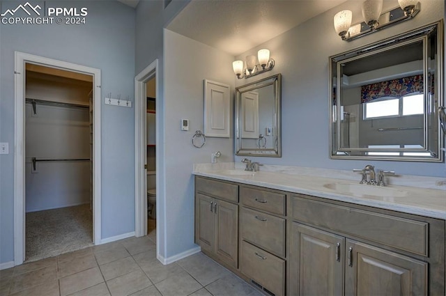 bathroom featuring tile patterned floors, vanity, and toilet