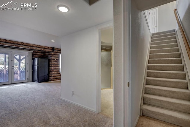 interior space featuring french doors and light colored carpet