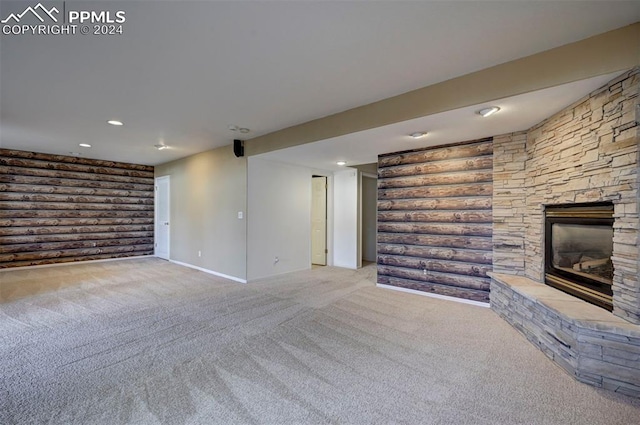 unfurnished living room with a stone fireplace and light carpet