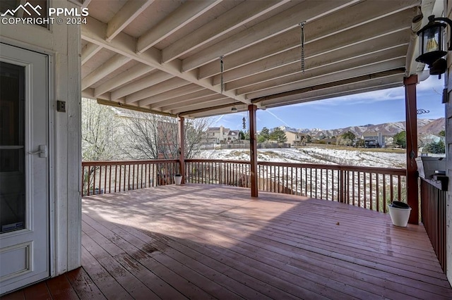 snow covered deck featuring a mountain view