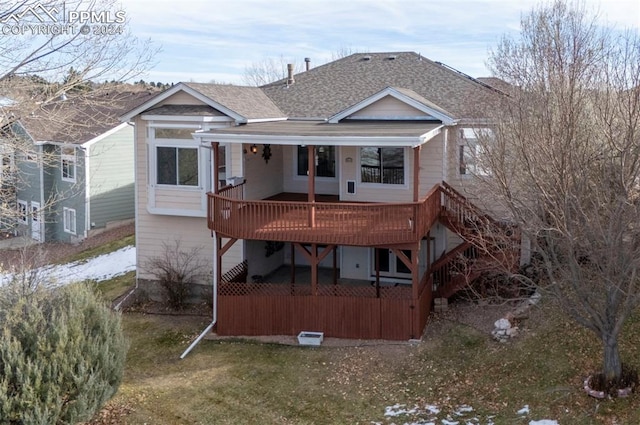 back of house featuring a wooden deck and a yard