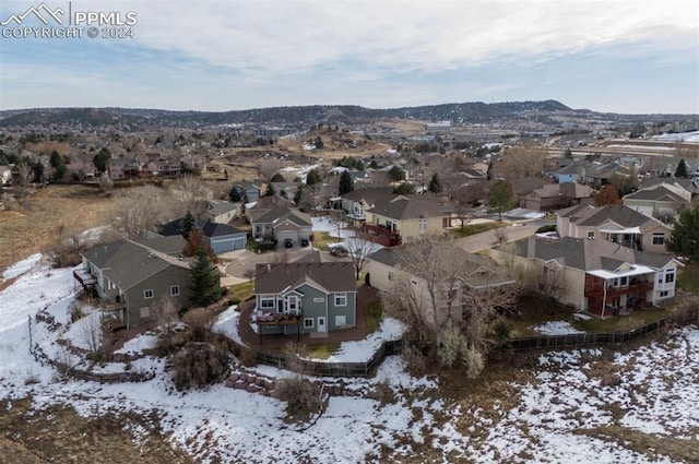 snowy aerial view featuring a mountain view