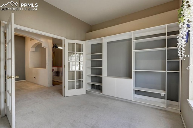 interior space featuring light carpet and french doors