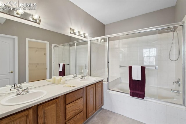 bathroom featuring vanity and bath / shower combo with glass door