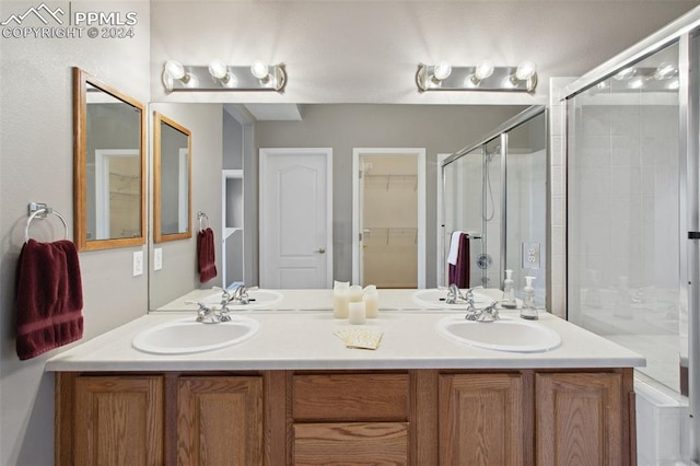 bathroom featuring vanity and a shower with shower door