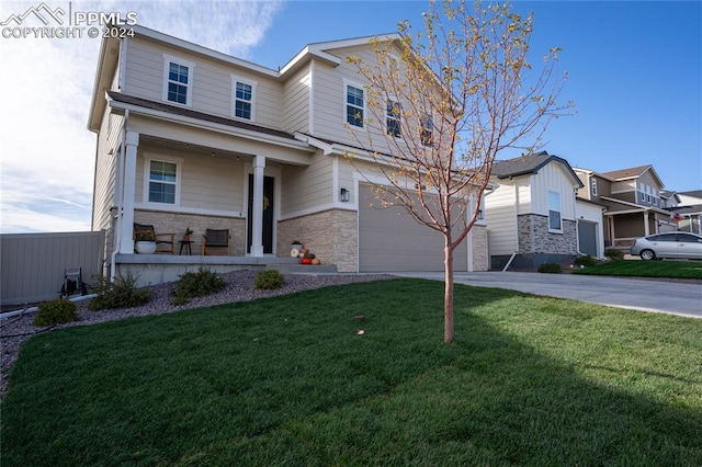 view of front of property featuring a porch, a garage, and a front lawn