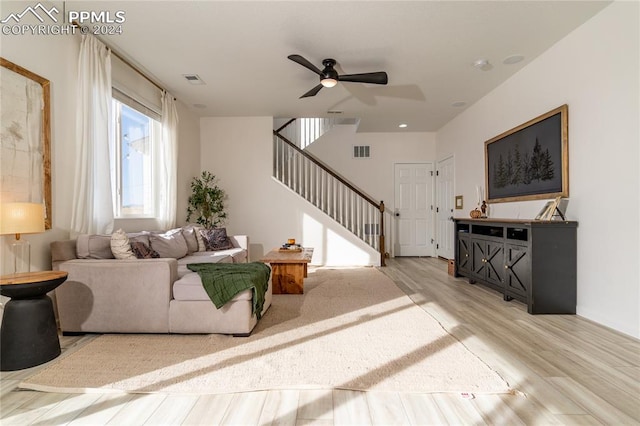 living room featuring ceiling fan and light hardwood / wood-style floors