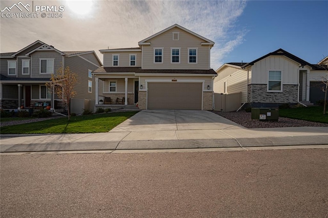 view of front of property featuring a lawn, central AC, and a garage