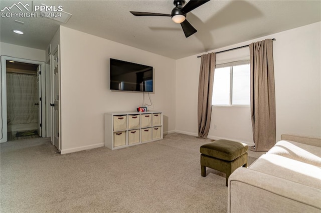 carpeted living room featuring ceiling fan