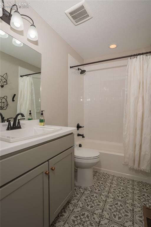 full bathroom featuring toilet, vanity, and shower / tub combo with curtain