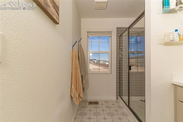 bathroom featuring vanity and an enclosed shower