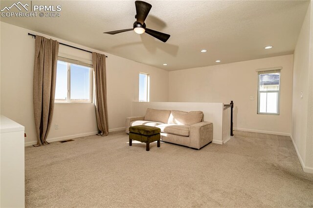 living room with ceiling fan and light carpet