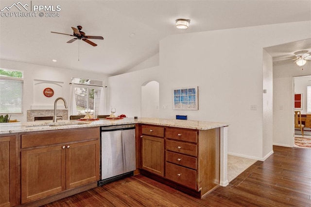 kitchen featuring dishwasher, sink, vaulted ceiling, dark hardwood / wood-style floors, and light stone counters