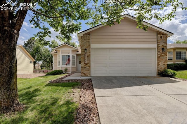 view of front of home featuring a front yard and a garage