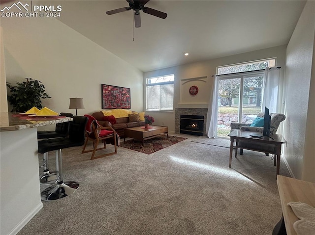 living room featuring ceiling fan, carpet, and vaulted ceiling