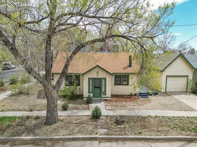 3 S 8th St, Colorado Springs, CO 80905 - view of front of house with stucco siding, a garage, concrete driveway, and a shingled roof