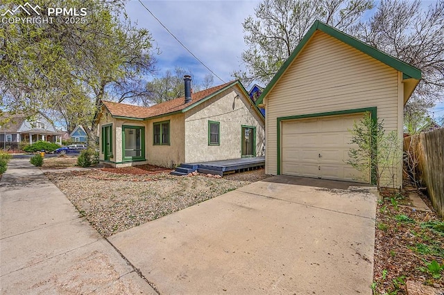 3 S 8th St, Colorado Springs, CO 80905 - view of front of property with a garage, driveway, and stucco siding