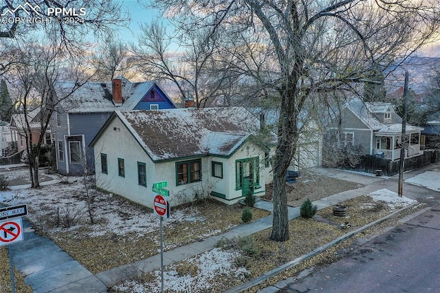 3 S 8th St, Colorado Springs, CO 80905 - view of front facade featuring stucco siding, a chimney, and a shingled roof