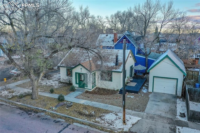 3 S 8th St, Colorado Springs, CO 80905 - view of front of home featuring a chimney, stucco siding, concrete driveway, and a garage