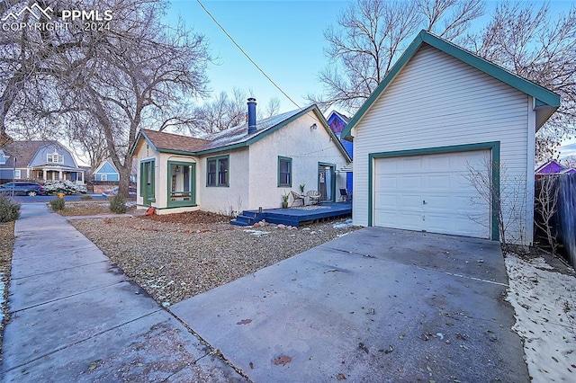 view of front facade featuring a garage and a deck