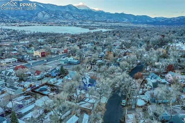 snowy aerial view with a mountain view