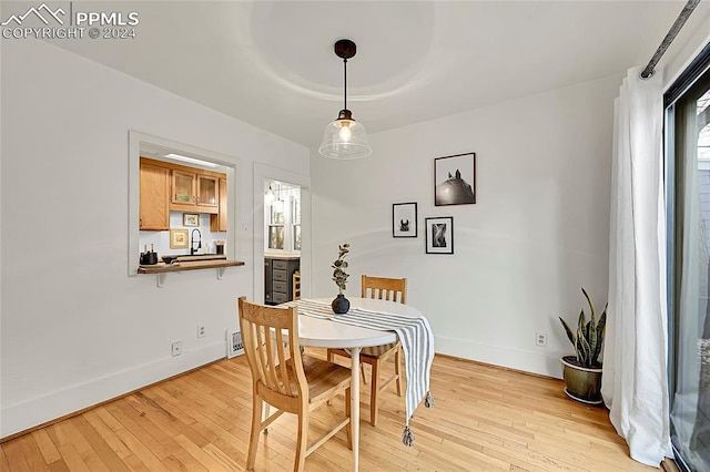 3 S 8th St, Colorado Springs, CO 80905 - dining space with light wood finished floors and baseboards