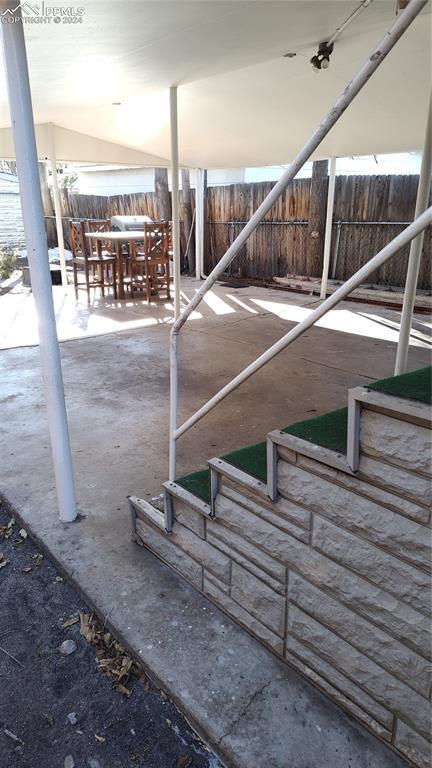 206 W Arroyo Ave, Pueblo, CO 81004 - view of patio featuring outdoor dining space and a fenced backyard
