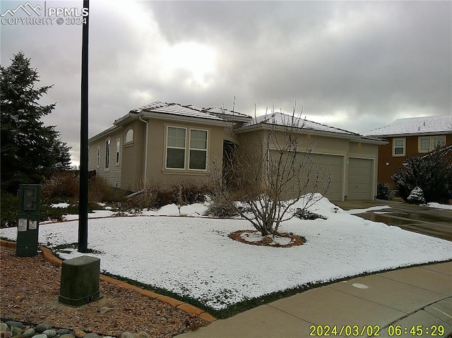 view of front of home featuring solar panels and a garage