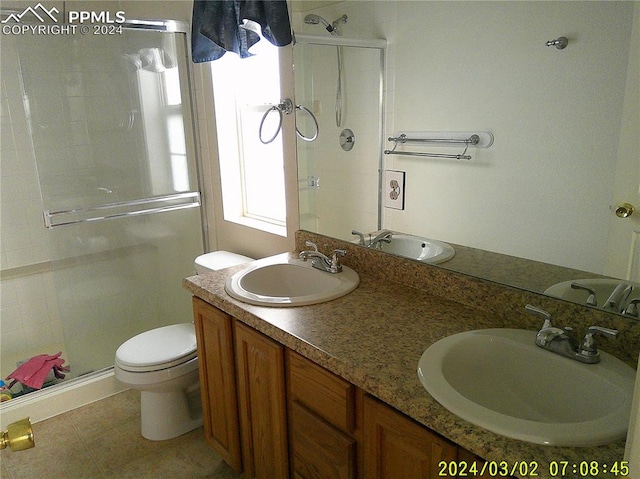 bathroom featuring tile patterned floors, vanity, toilet, and walk in shower