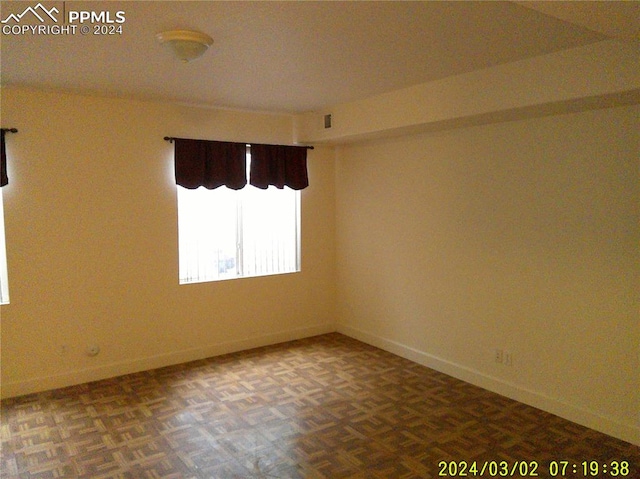 empty room with parquet flooring