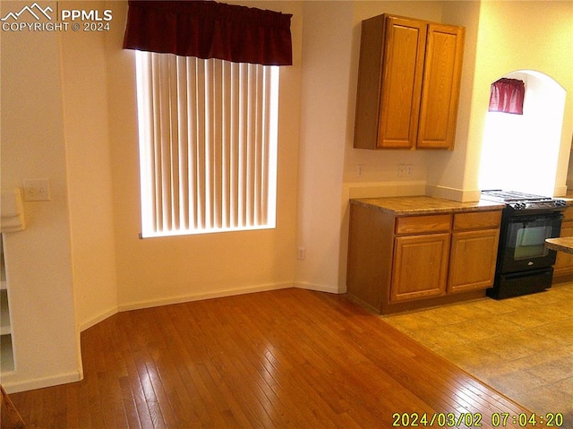 kitchen featuring black stove and light wood-type flooring