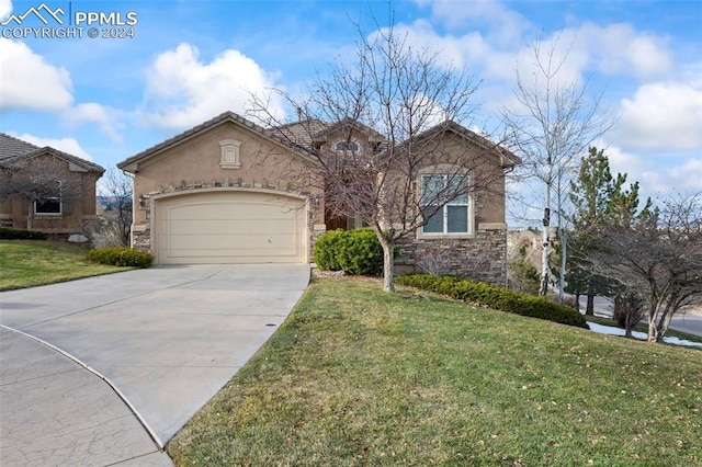 view of front of house with a garage and a front lawn