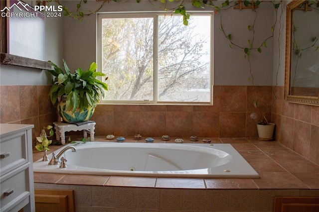 bathroom with vanity and a relaxing tiled tub