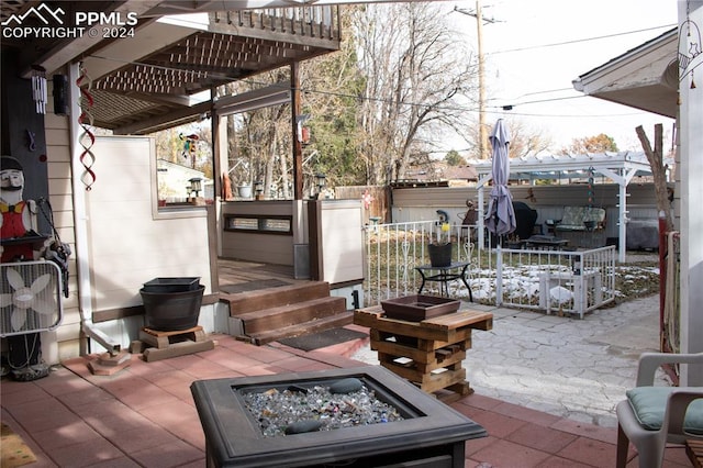 view of patio with a fire pit and a pergola