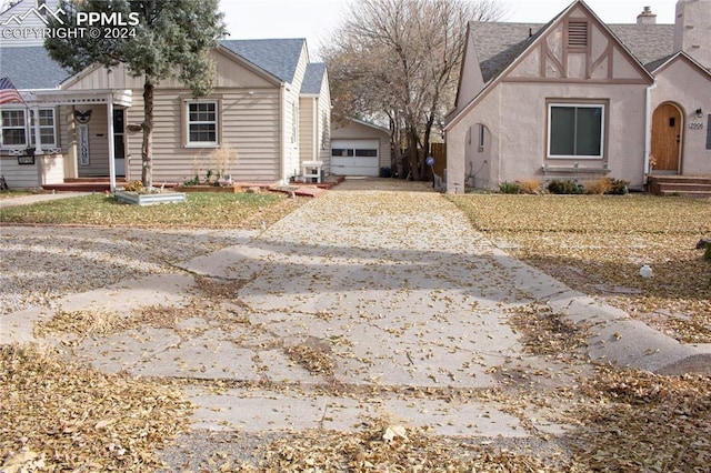 view of front of property with a garage and an outdoor structure