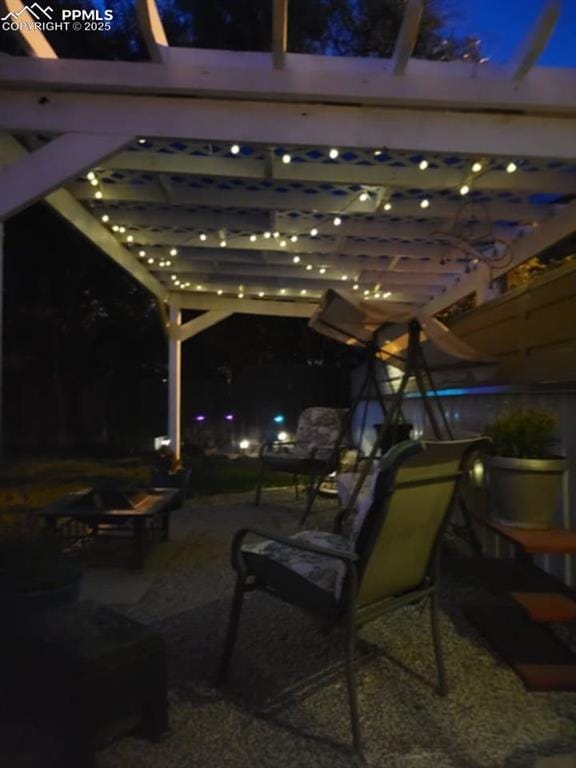 patio at twilight featuring a pergola