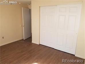 unfurnished bedroom featuring dark hardwood / wood-style floors and a closet