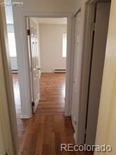 hallway featuring dark hardwood / wood-style flooring and a baseboard radiator