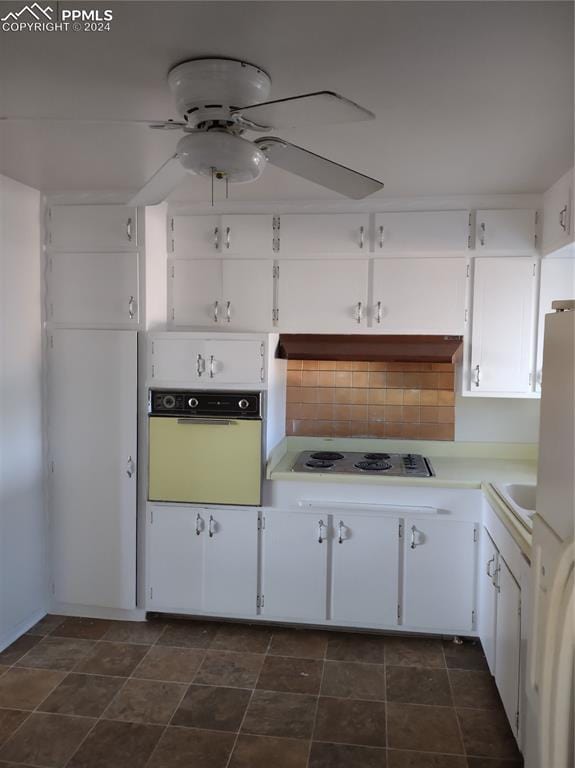 kitchen featuring tasteful backsplash, white cabinetry, and white appliances