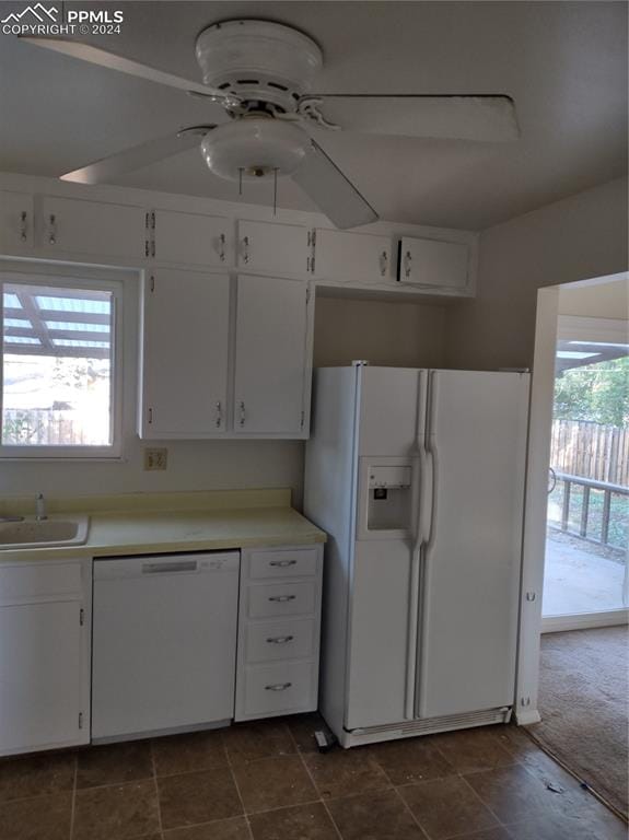 kitchen featuring plenty of natural light, white cabinets, and white appliances