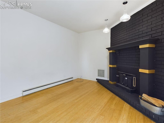 unfurnished living room with a baseboard radiator and hardwood / wood-style flooring